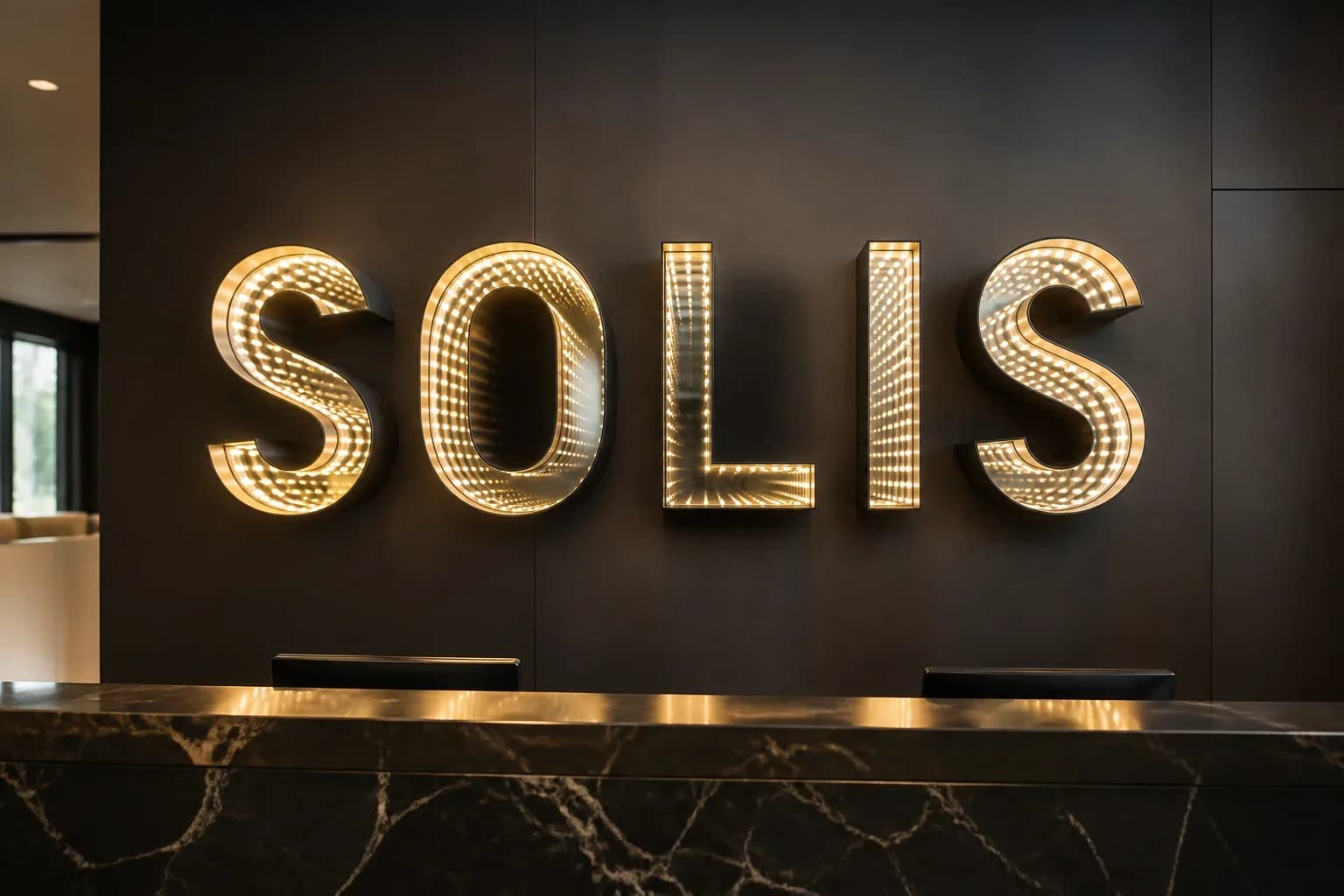 Reception wall with an infinity letter wordmark showing even warm-white tunnel depth across every character